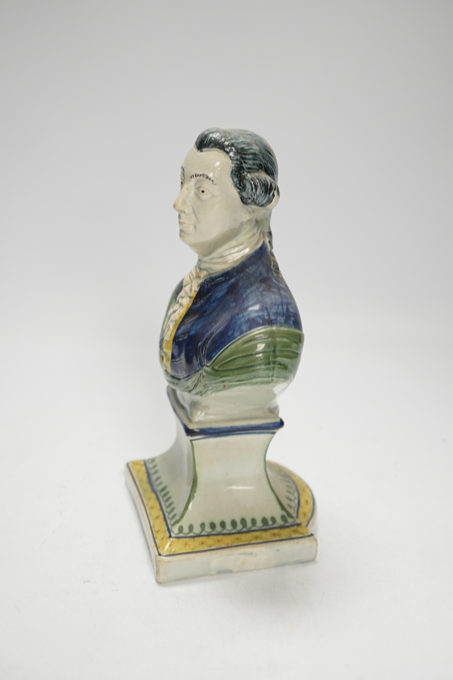 A Staffordshire pearlware portrait bust of a gentleman, possibly William Pitt the Younger, c.1790, painted in Pratt type colours, 23cm high